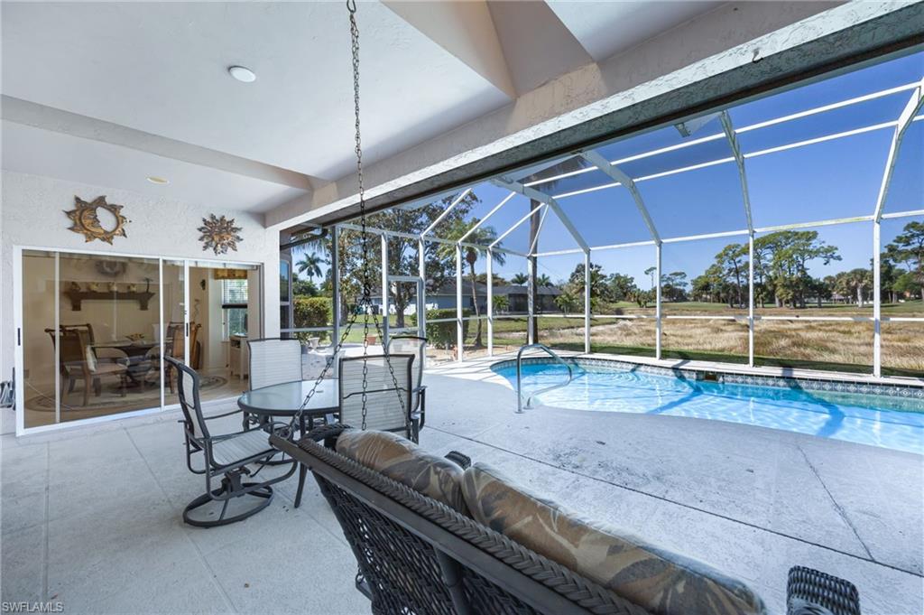 867 St Andrews Boulevard Naples, FL 34113 - Photo 24 of 28 a view of a room with gym equipment and large window