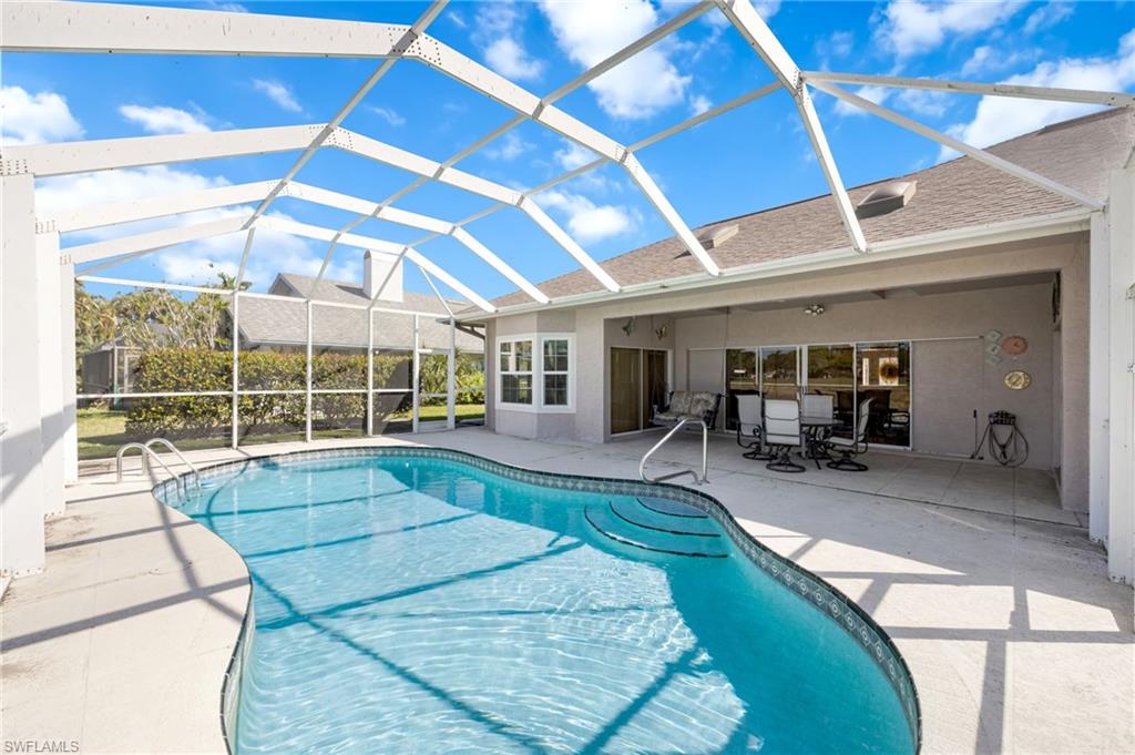 867 St Andrews Boulevard Naples, FL 34113 - Photo 25 of 28 a view of a house with swimming pool and sitting area