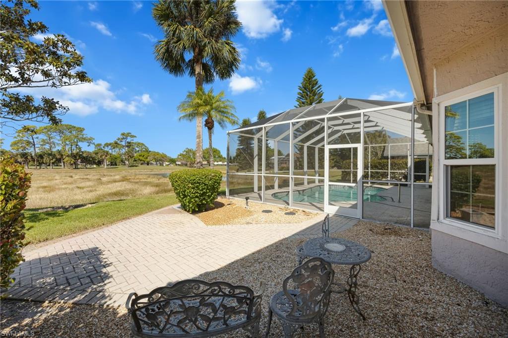 867 St Andrews Boulevard Naples, FL 34113 - Photo 28 of 28 a view of a house with backyard porch and sitting area