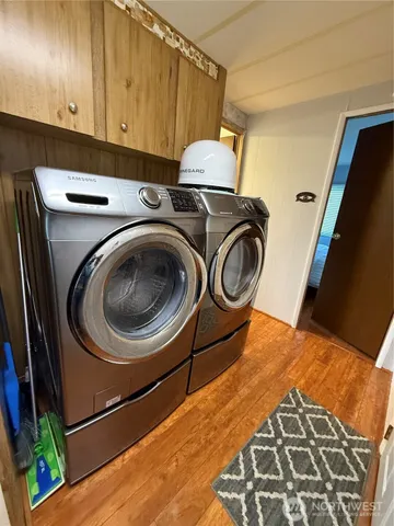 a utility room with sink dryer and washer