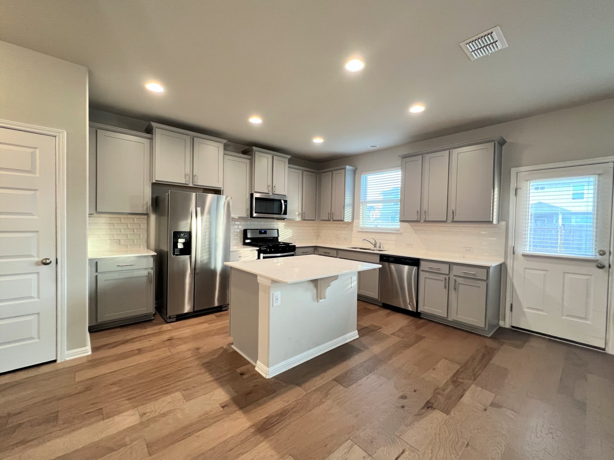 6413 Owl Creek Lane Austin, TX 78747 - Photo 3 of 23 a kitchen with a refrigerator a sink and cabinets