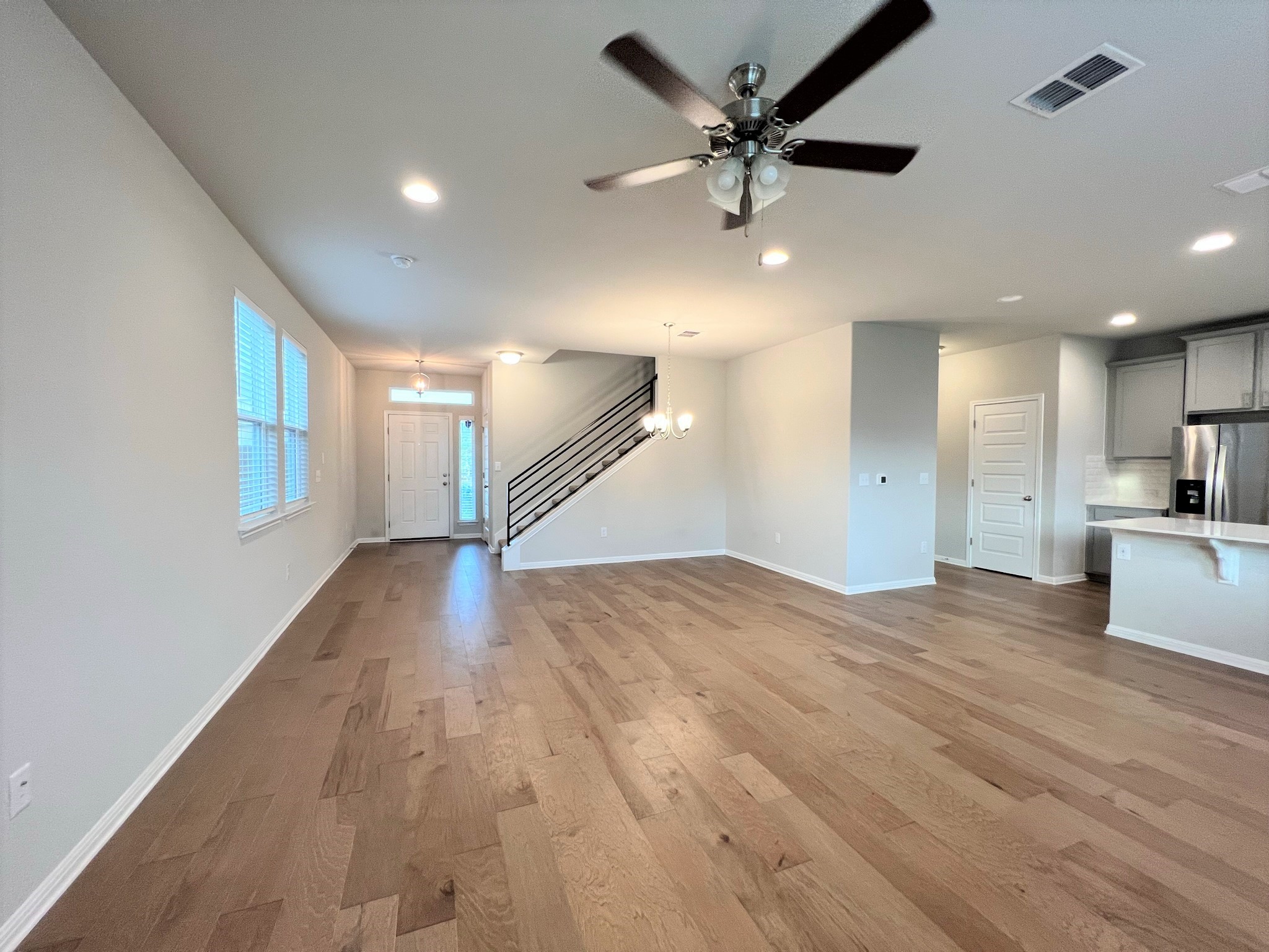 6413 Owl Creek Lane Austin, TX 78747 - Photo 4 of 23 a view of empty room with wooden floor and fan