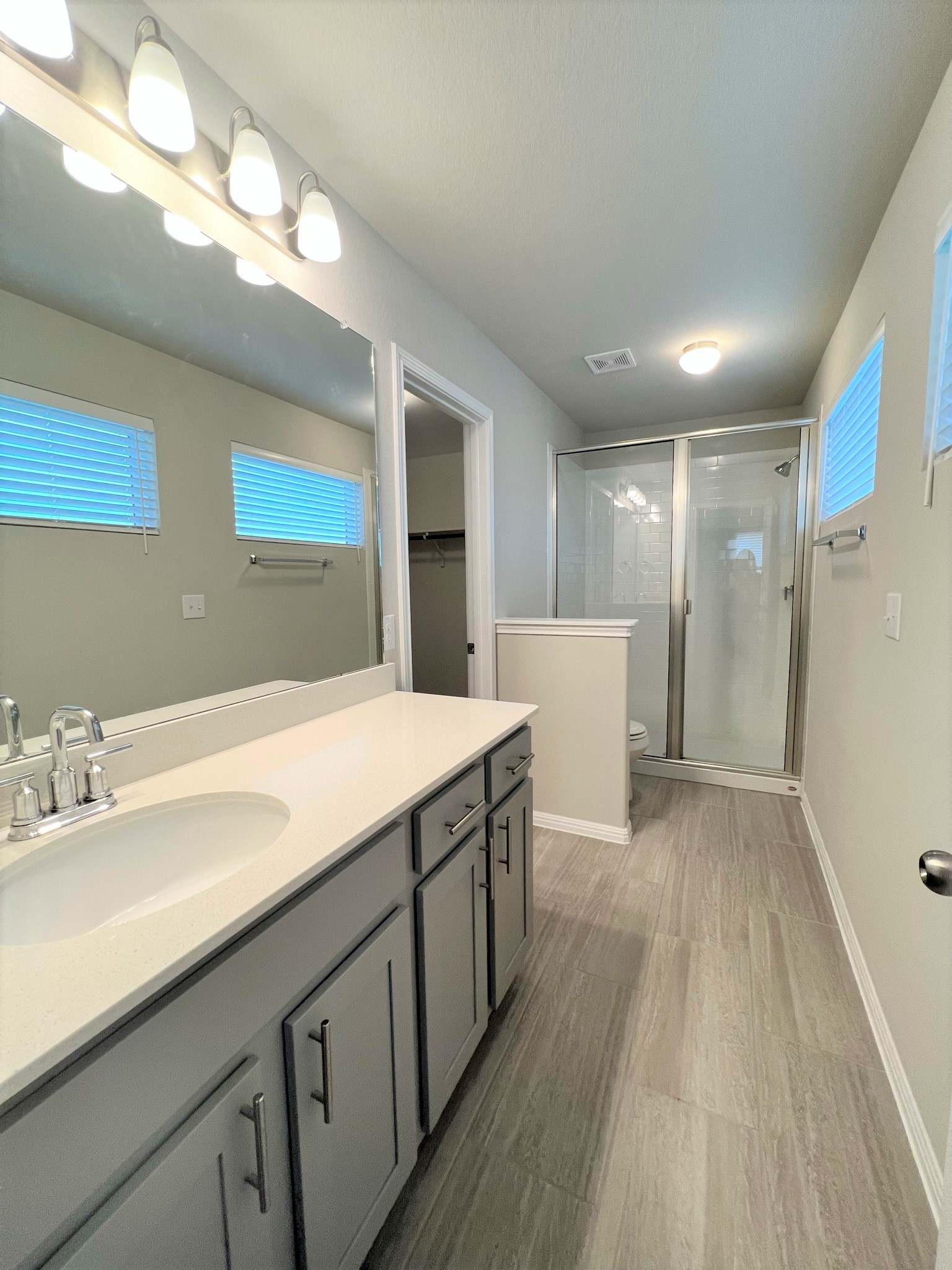 6413 Owl Creek Lane Austin, TX 78747 - Photo 8 of 23 a bathroom with a sink a large mirror and vanity
