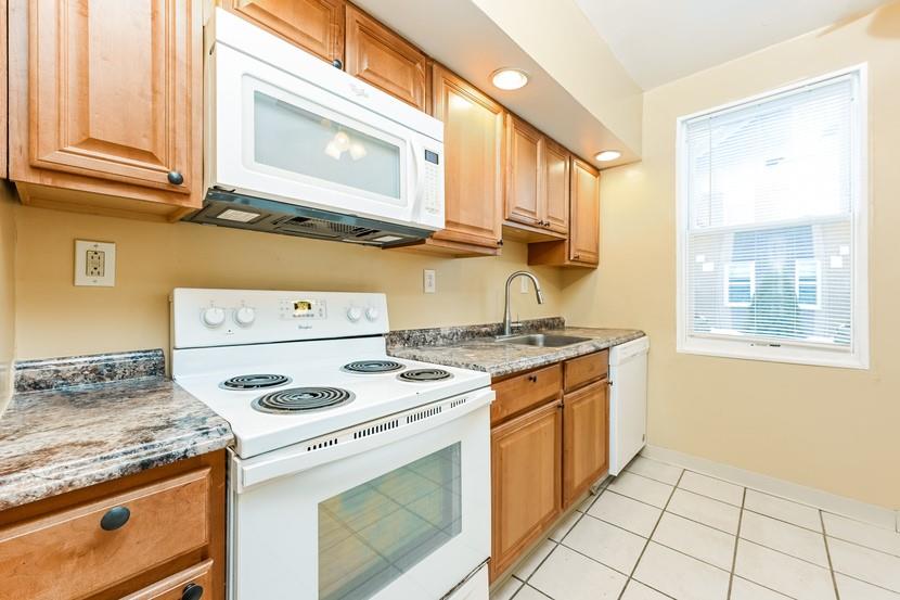 6472 Monitor Street Pittsburgh, PA 15217 - Photo 13 of 39 a stove top oven sitting inside of a kitchen