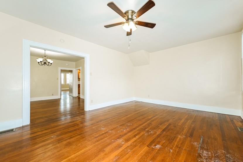 6472 Monitor Street Pittsburgh, PA 15217 - Photo 14 of 39 an empty room with wooden floor and a ceiling fan