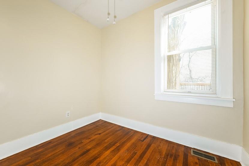 6472 Monitor Street Pittsburgh, PA 15217 - Photo 21 of 39 an empty room with wooden floor and windows