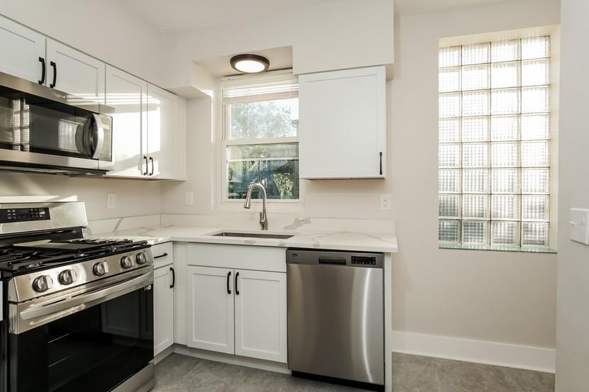 6472 Monitor Street Pittsburgh, PA 15217 - Photo 30 of 39 a kitchen with cabinets stainless steel appliances a sink and a window