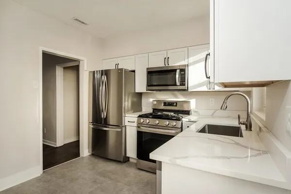 a kitchen with a refrigerator stove and microwave