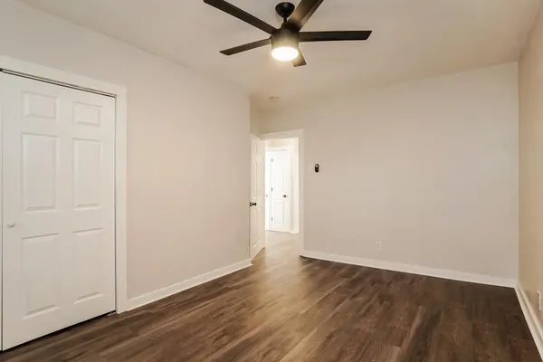 a view of an empty room with wooden floor