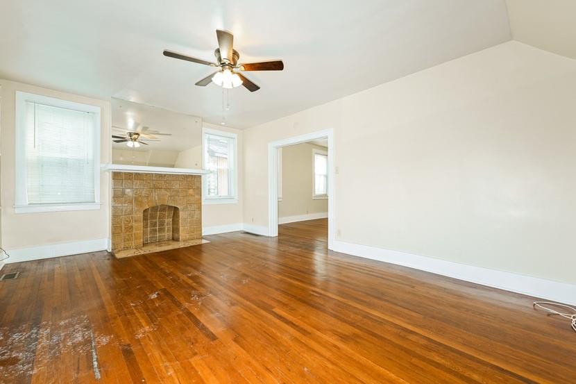 6472 Monitor Street Pittsburgh, PA 15217 - Photo 7 of 39 a view of an empty room with wooden floor and a fireplace