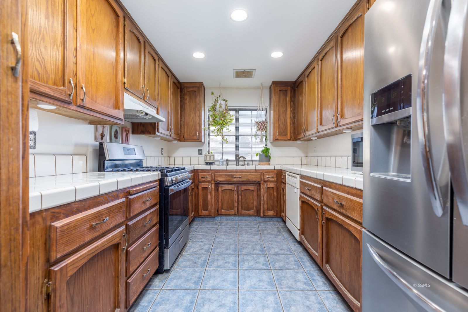 331 Henry Street Ridgecrest, CA 93555 - Photo 8 of 30 a kitchen with stainless steel appliances granite countertop a sink a stove top oven a refrigerator and cabinets