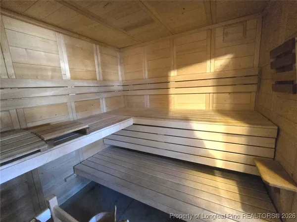 a view of gym equipment with wooden floor
