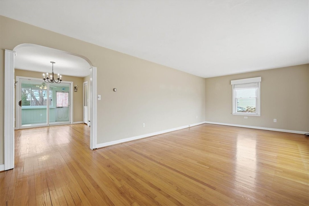80 Maplecrest Drive Pawtucket, RI 02861 - Photo 11 of 44 Featuring gleaming hardwood floors throughout and charming arched doorways that add architectural interest, this home offers a warm and inviting layout filled with natural light.