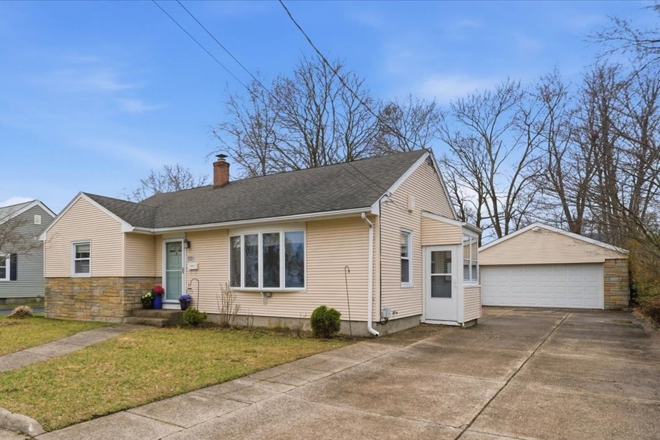 80 Maplecrest Drive Pawtucket, RI 02861 - Photo 2 of 44 Set on a well-landscaped lot, the property welcomes you with mature plantings, highlighted by a stunning maple tree that adds both shade and seasonal beauty. A massive driveway easily accommodates 6+ vehicles and leads to an oversized 2-car garage (approx. 420 sq ft), offering exceptional space for parking, storage, or hobby use.