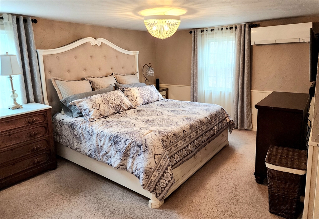 49 Edward Road Townsend, MA 01469 - Photo 27 of 41 a large bed sitting in a bedroom next to a window
