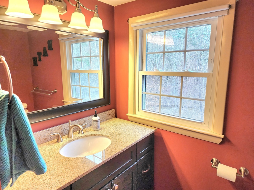 49 Edward Road Townsend, MA 01469 - Photo 35 of 41 a bathroom with a granite countertop sink and a window