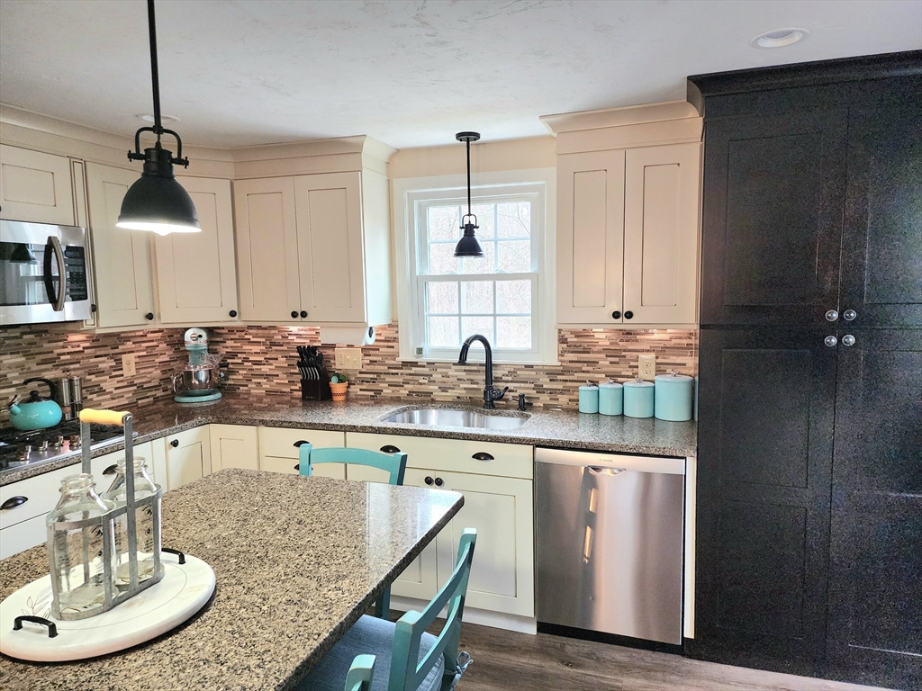 49 Edward Road Townsend, MA 01469 - Photo 10 of 41 a kitchen with center island table and chairs