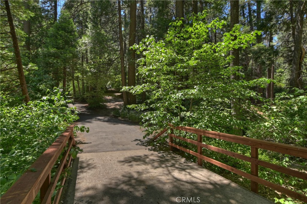 714 Blue Jay Canyon Road Lake Arrowhead, CA 92317 - Photo 6 of 15 "over the river and through the woods". House is the drive way to the right. Only 2 homes back here with a running stream below bridge
