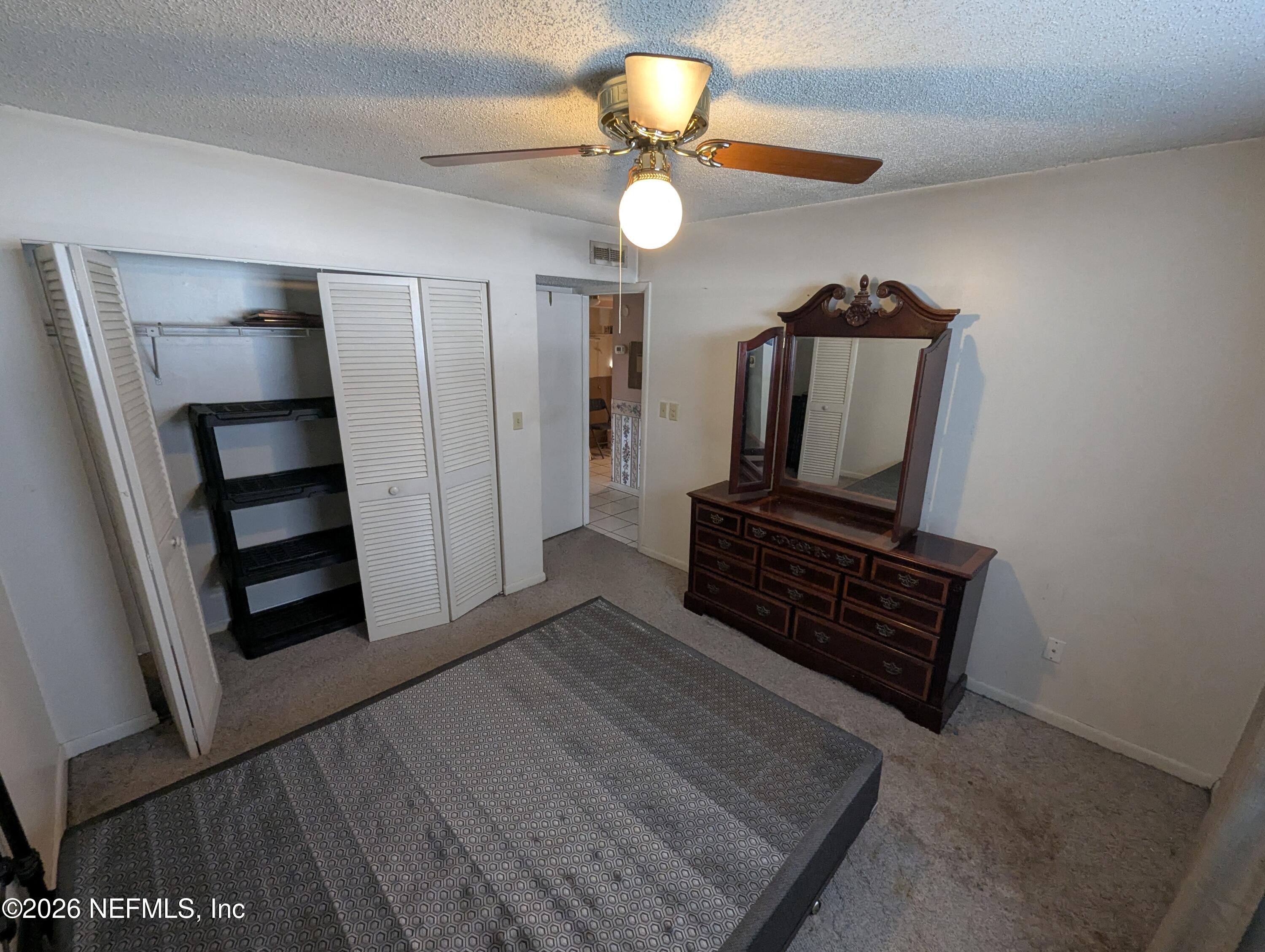 7206 Cypress Cove Road, Unit 14 Jacksonville, FL 32244 - Photo 14 of 23 a living room with furniture and a flat screen tv