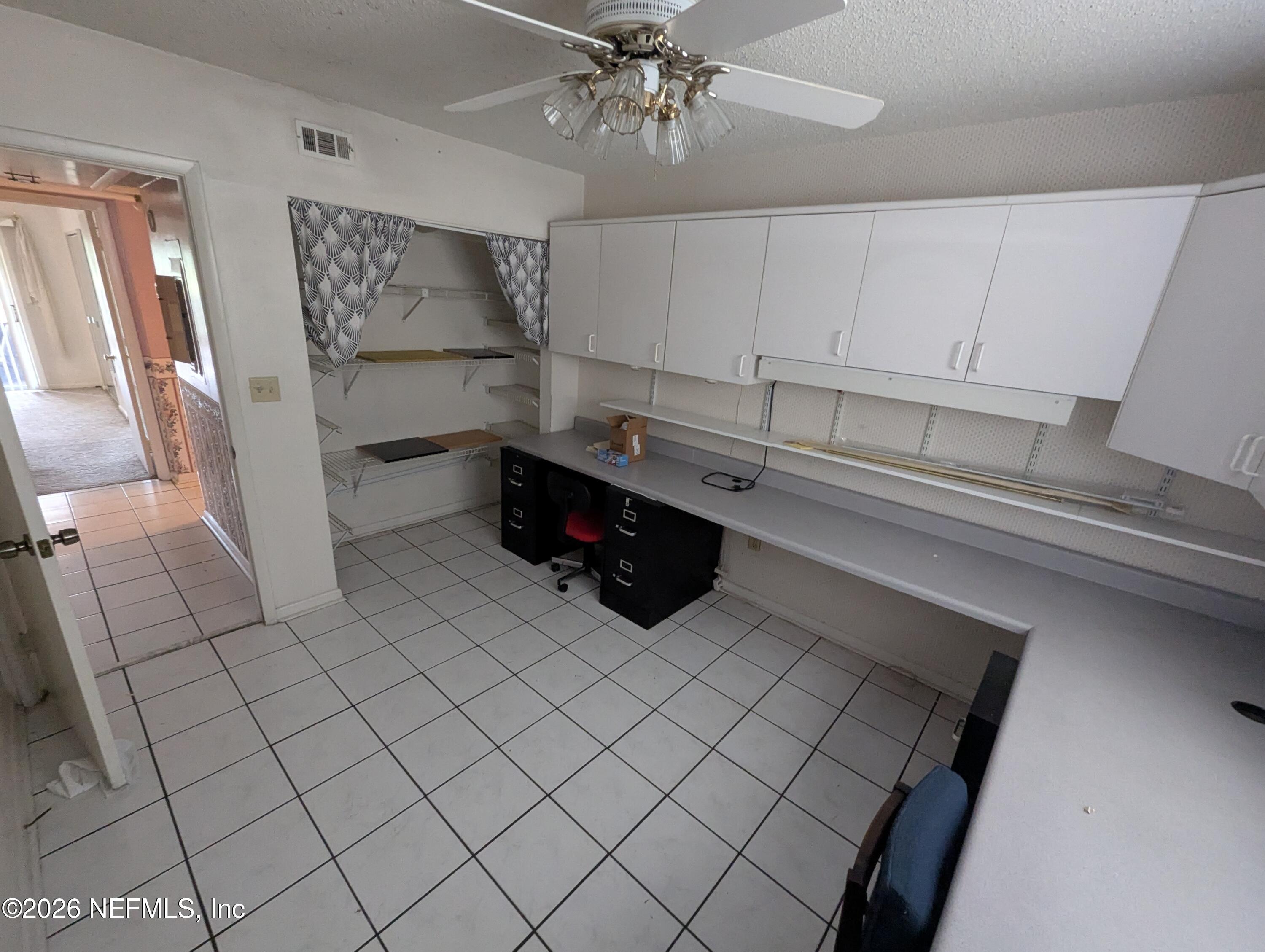 7206 Cypress Cove Road, Unit 14 Jacksonville, FL 32244 - Photo 16 of 23 a kitchen with white cabinets and window
