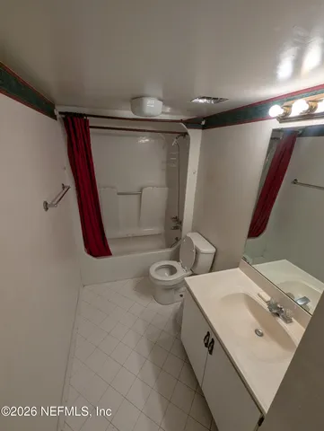 a bathroom with a double vanity sink toilet and shower