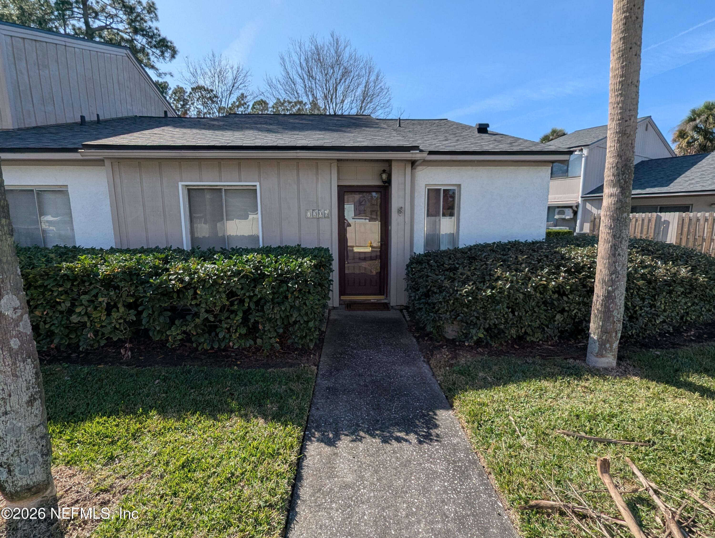 7206 Cypress Cove Road, Unit 14 Jacksonville, FL 32244 - Photo 2 of 23 a front view of a house with a yard