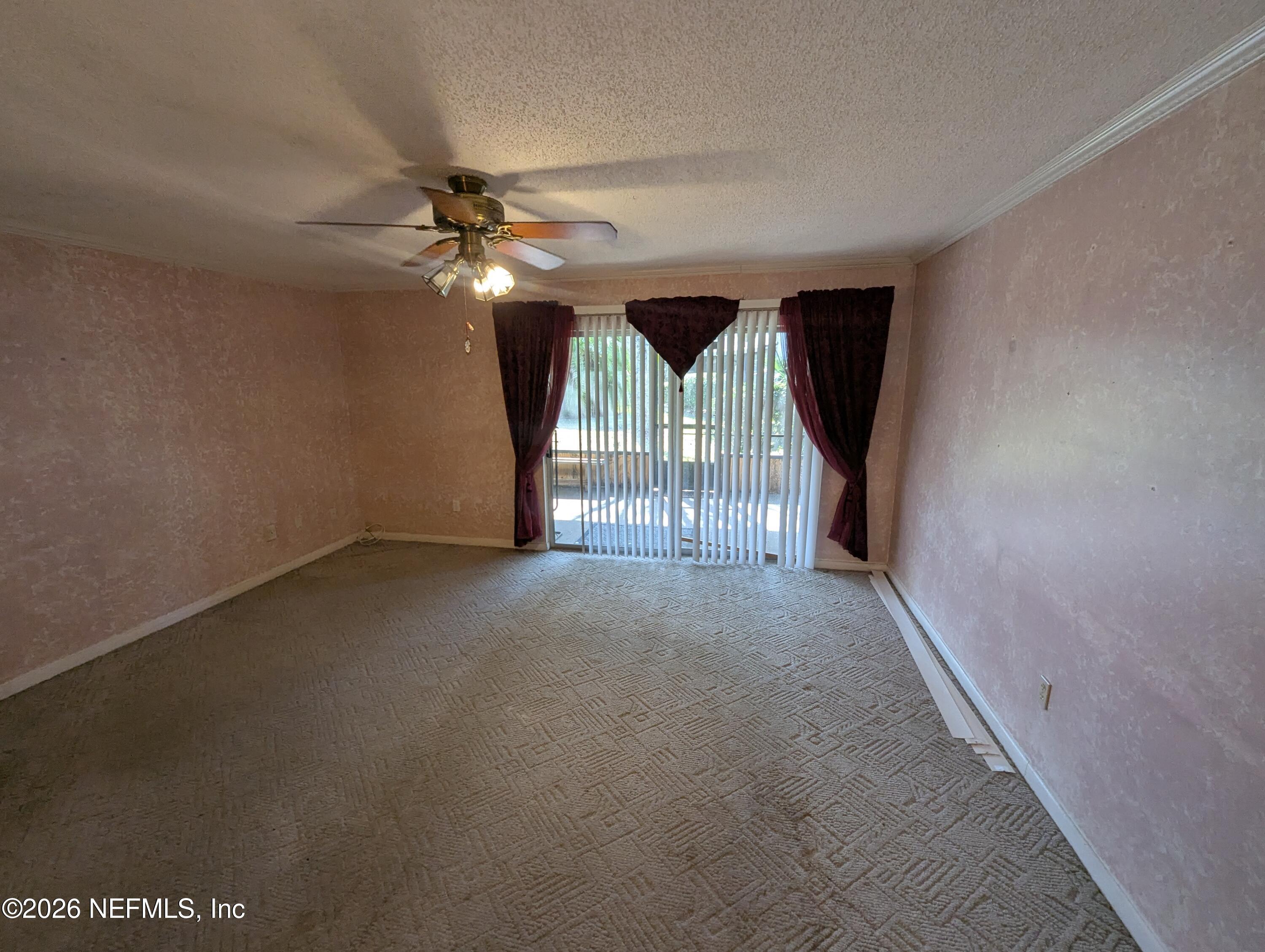 7206 Cypress Cove Road, Unit 14 Jacksonville, FL 32244 - Photo 7 of 23 a view of a livingroom with a ceiling fan and window