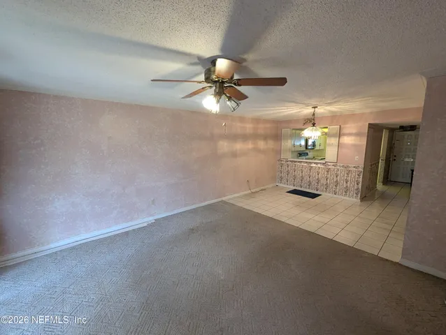 a view of a room with a ceiling fan and chandelier fan