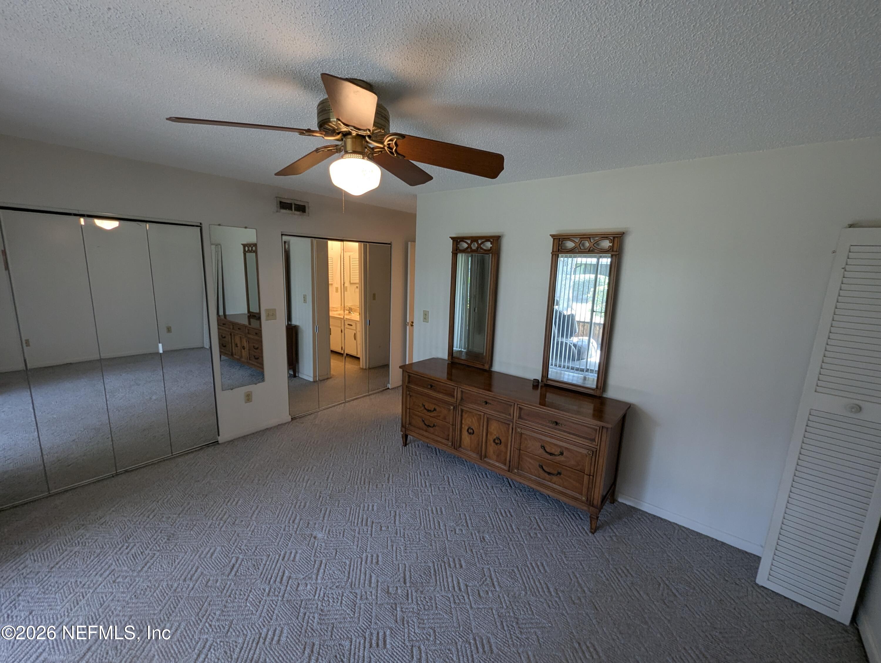 7206 Cypress Cove Road, Unit 14 Jacksonville, FL 32244 - Photo 10 of 23 a living room with furniture and a chandelier