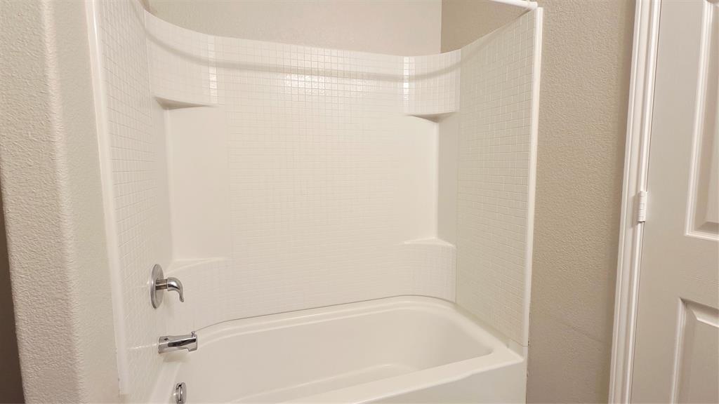 824 Rivers Creek Lane Little Elm, TX 75068 - Photo 13 of 20 a bathroom with a bathtub