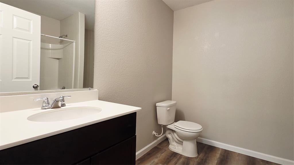 824 Rivers Creek Lane Little Elm, TX 75068 - Photo 14 of 20 a bathroom with a toilet a sink and mirror