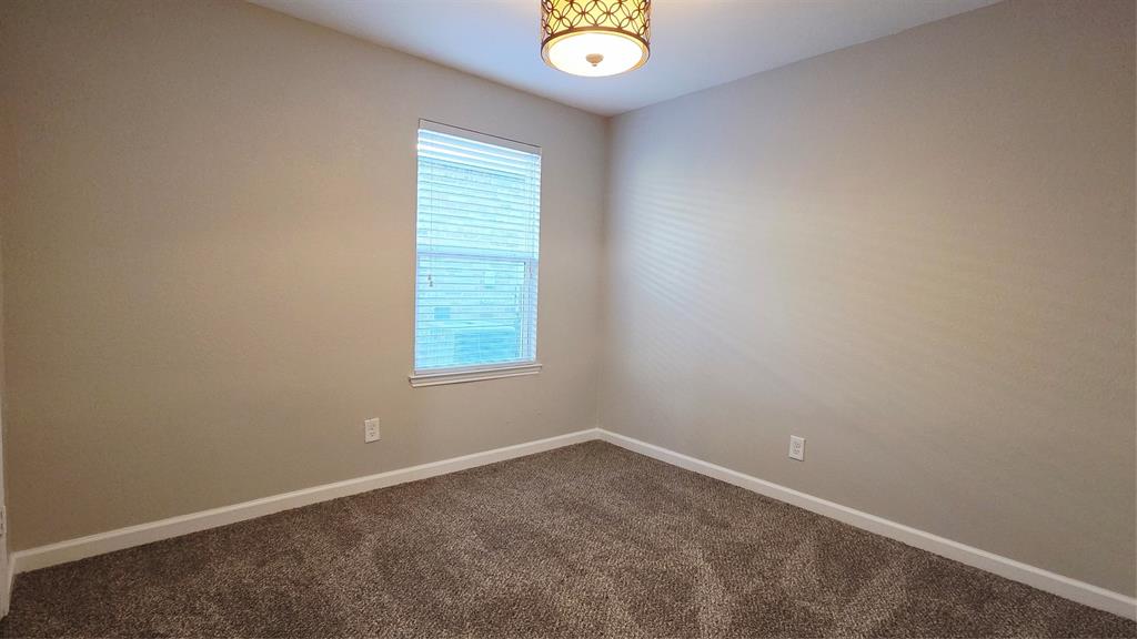 824 Rivers Creek Lane Little Elm, TX 75068 - Photo 15 of 20 an empty room with window and ceiling fan