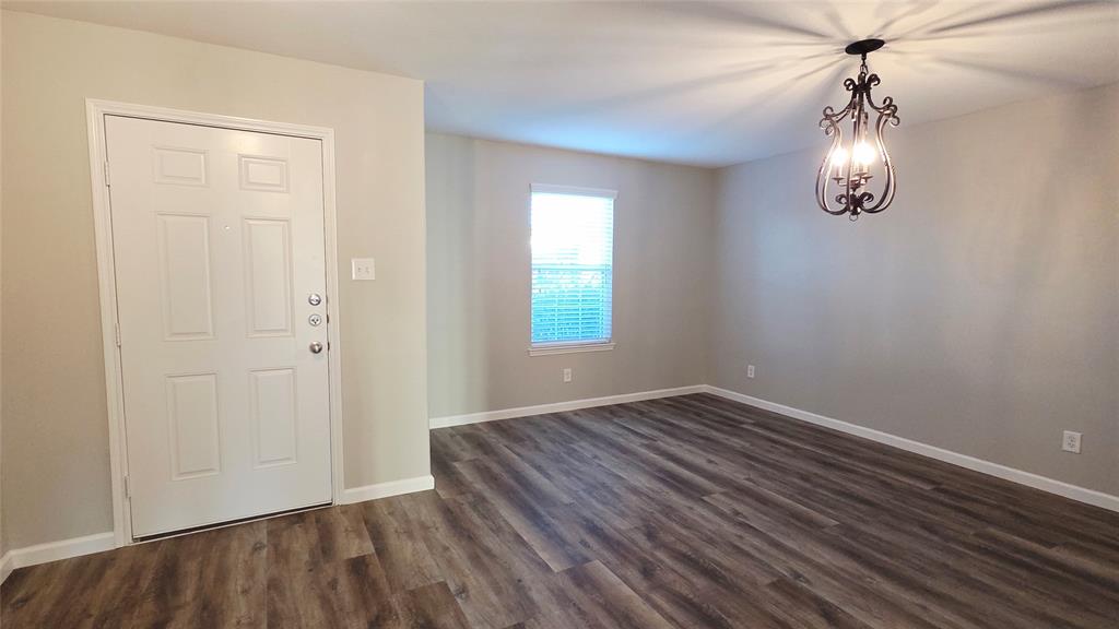 824 Rivers Creek Lane Little Elm, TX 75068 - Photo 2 of 20 wooden floor in an empty room with a window