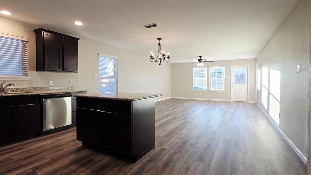 824 Rivers Creek Lane Little Elm, TX 75068 - Photo 5 of 20 a kitchen with granite countertop a refrigerator and a sink