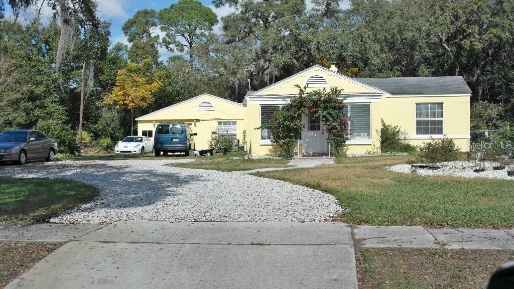 141 Sunnytown Road Casselberry, FL 32707 - Photo 1 of 18 a front view of a house with a yard and trees