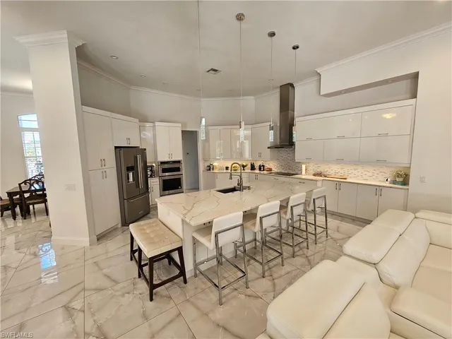 a kitchen with stainless steel appliances kitchen island granite countertop a sink and cabinets