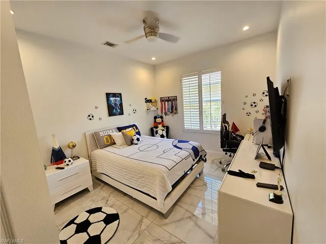 a bedroom with bed and a flat screen tv