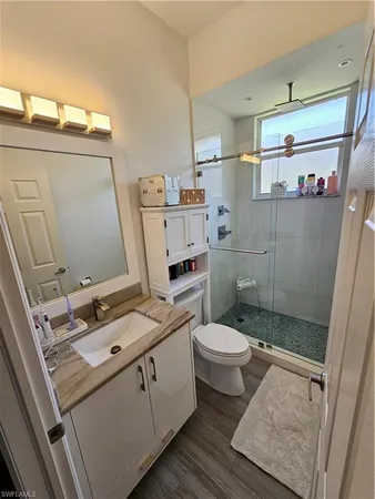 a bathroom with a sink toilet and shower