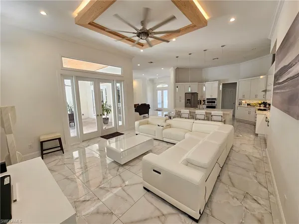 a living room with furniture and a chandelier