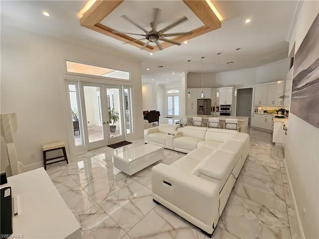 a living room with furniture and a chandelier