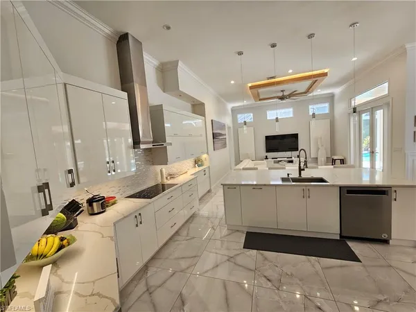 a large white kitchen with a large window