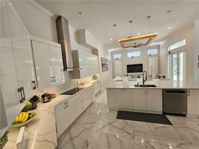 a large white kitchen with a large window