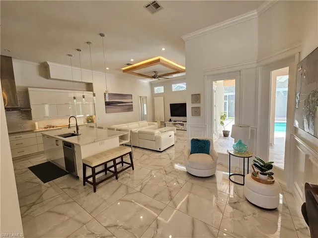 a living room with patio furniture and a fireplace