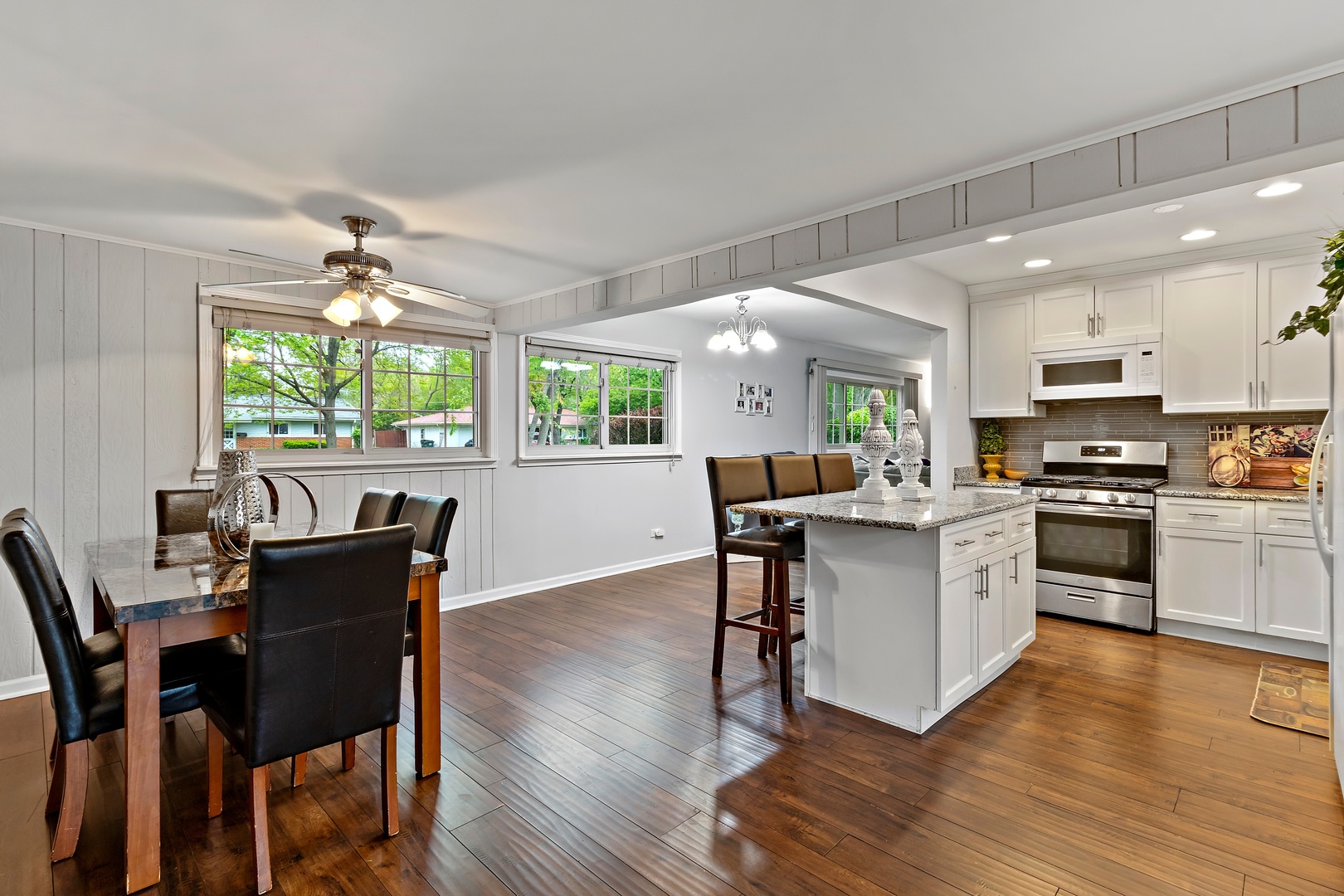 245 Washington Boulevard Hoffman Estates, IL 60169 - Photo 9 of 19 a kitchen with a table chairs microwave and cabinets
