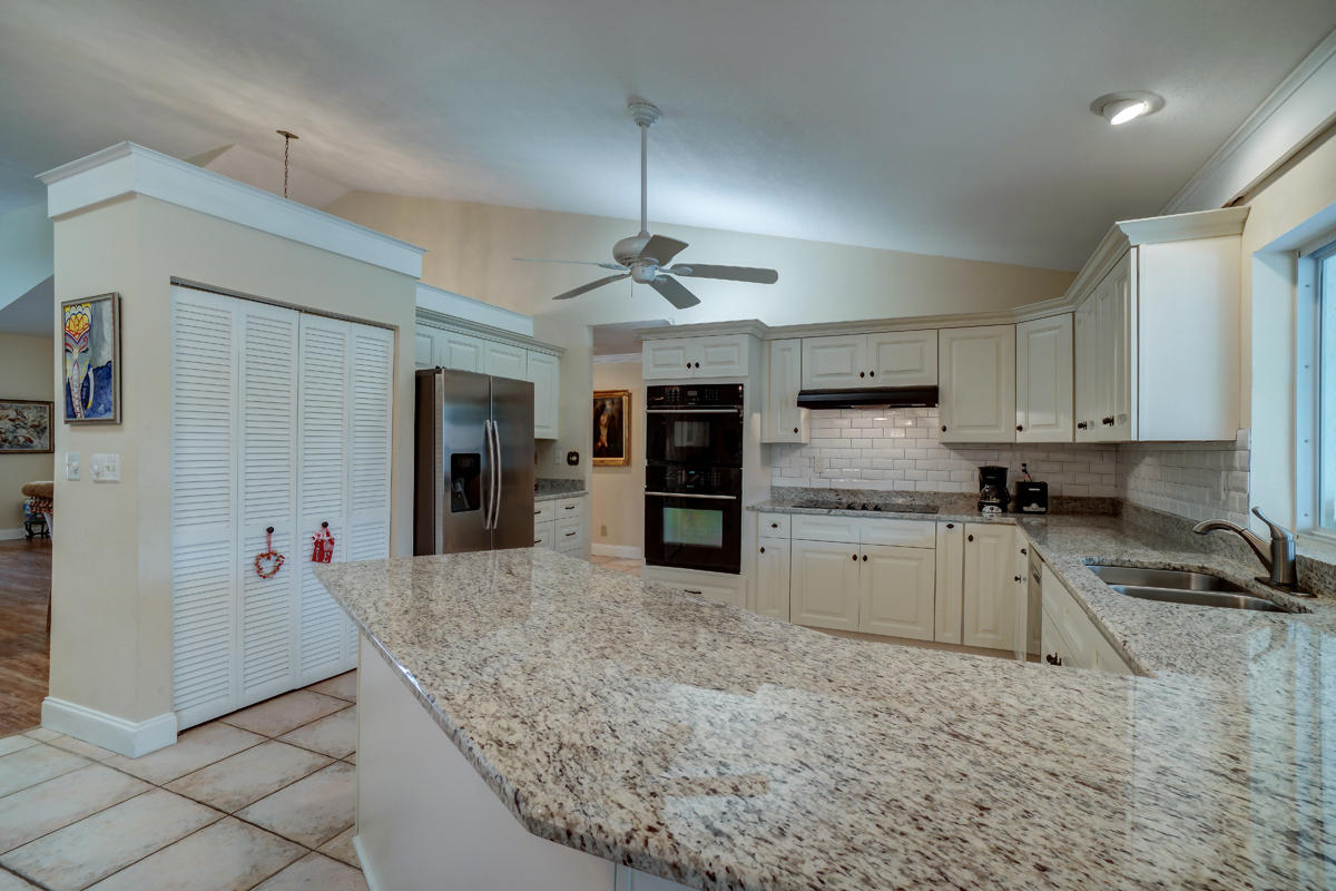 22790 Pinewood Court Boca Raton, FL 33433 - Photo 8 of 33 Granite Kitchen with White Subway Tile