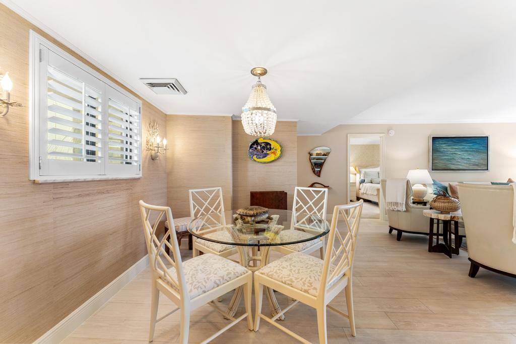 200 Ocean Trail Way, Unit T7 Jupiter, FL 33477 - Photo 12 of 46 a dining room with a wooden table and chairs