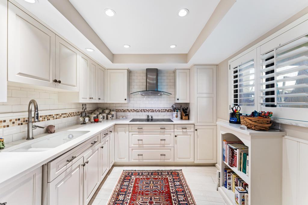 200 Ocean Trail Way, Unit T7 Jupiter, FL 33477 - Photo 13 of 46 a kitchen with a sink stove and cabinets