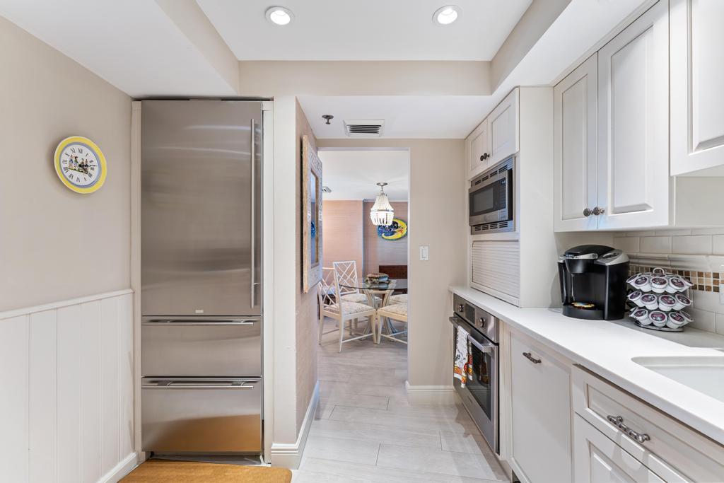200 Ocean Trail Way, Unit T7 Jupiter, FL 33477 - Photo 16 of 46 a kitchen with a refrigerator and microwave