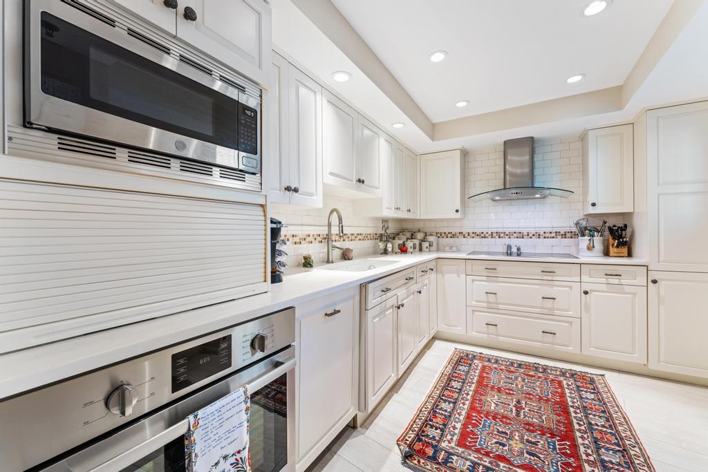 200 Ocean Trail Way, Unit T7 Jupiter, FL 33477 - Photo 17 of 46 a kitchen with granite countertop stainless steel appliances and cabinets