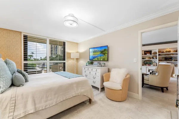 a bedroom with a bed and a flat screen tv in it